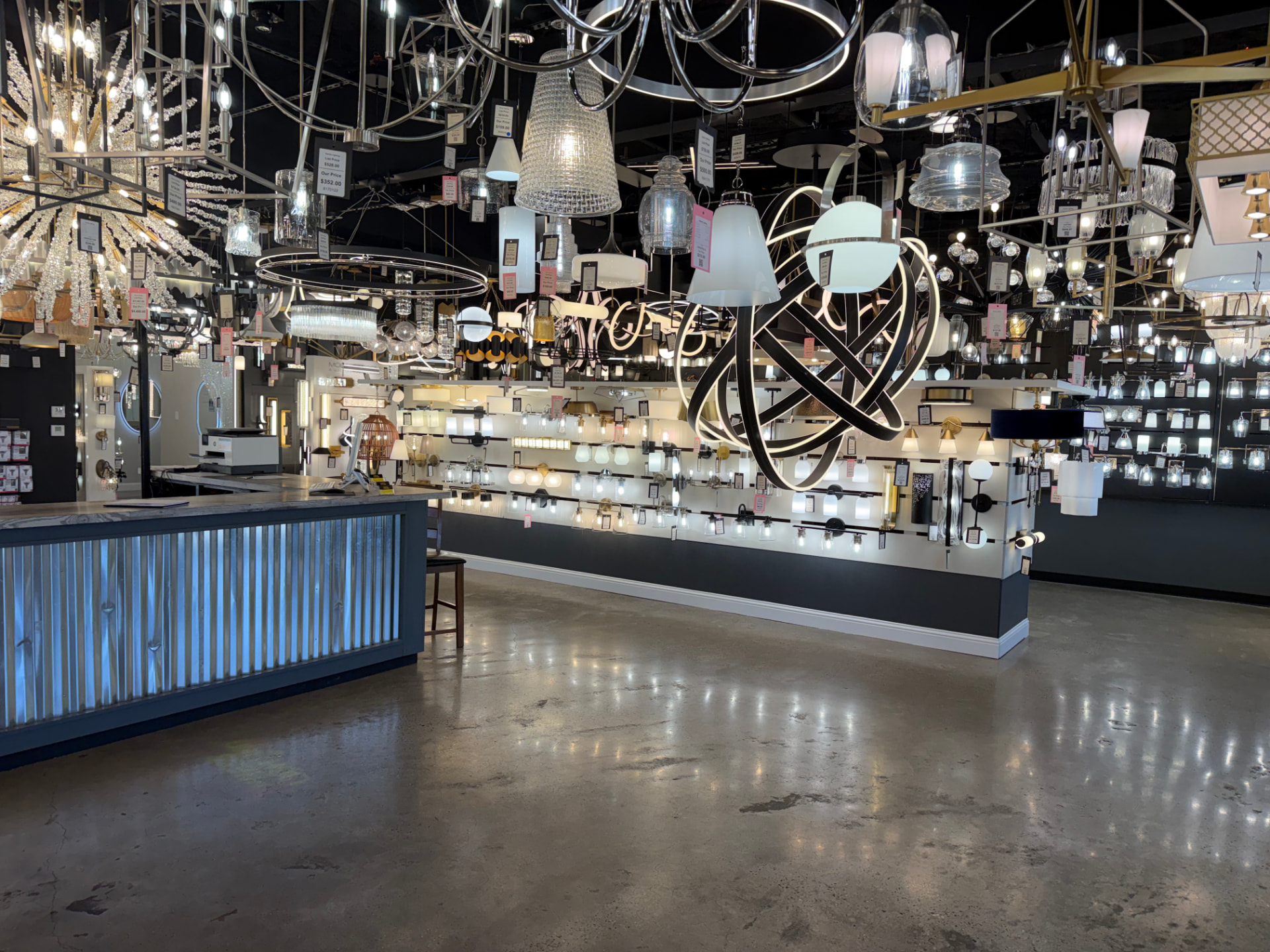 Illuminated chandeliers, lanterns, and decorative lighting inside the Xpress Lighting showroom
